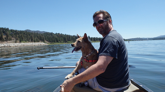 The writer and his dog boating on the lake